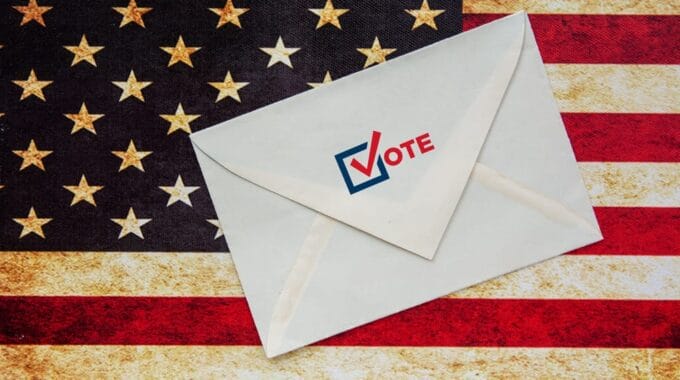 US Flag with Ballot Envelope with Vote on it.