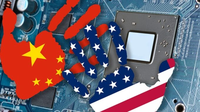Colors of Chinese US Flags in Shapes of Hands over Graphics Card