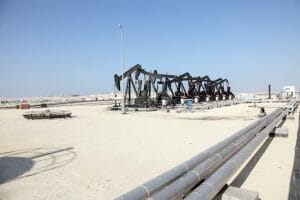 Black oil pump jacks in the desert of Bahrain, Middle East