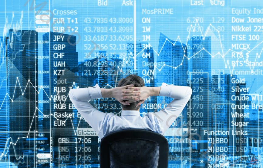 Relaxing Trader in front of stock market screen