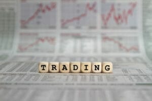 Trading Trading in words on wooden blocks with newspaper background