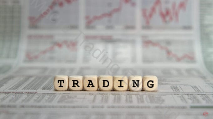 Trading in words on wooden blocks with newspaper background